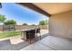 Covered patio with an outdoor dining set overlooking the landscaped backyard at 26020 N 138Th Ln, Peoria, AZ 85383