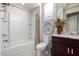 Well-lit bathroom featuring a tub, shower with a curtain, and a granite-topped vanity at 26509 W Ponderosa Ln, Buckeye, AZ 85396