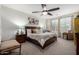 Bright and airy bedroom features a ceiling fan and natural light from the window at 26509 W Ponderosa Ln, Buckeye, AZ 85396