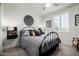 Stylized bedroom with gray bedding, side tables, and a decorative art piece at 26509 W Ponderosa Ln, Buckeye, AZ 85396