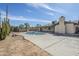 Lovely backyard pool and deck with desert landscaping under bright blue sky at 2728 W Redfield Rd, Phoenix, AZ 85053