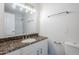 Bathroom features a double vanity, granite countertop, modern lighting, and tiled shower at 2728 W Redfield Rd, Phoenix, AZ 85053