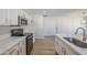 Renovated kitchen featuring sleek, stainless appliances, and white marble countertops at 2728 W Redfield Rd, Phoenix, AZ 85053