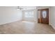 Bright living room featuring neutral-toned vinyl flooring, a window, and a stylish front door at 2728 W Redfield Rd, Phoenix, AZ 85053