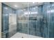 Bathroom shower with blue vertical tile, glass surround, bench and two shower heads at 2749 E Wier Ave, Phoenix, AZ 85040