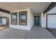 Covered entry to home with light-blue door, white stucco, and a peek at the two-car garage at 2749 E Wier Ave, Phoenix, AZ 85040