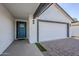 Charming front exterior features a light-blue front door, white stucco, and a two-car garage at 2749 E Wier Ave, Phoenix, AZ 85040