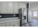 Kitchen with stainless steel refrigerator, quartz countertops, and classic cabinetry at 2749 E Wier Ave, Phoenix, AZ 85040