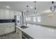 Modern kitchen with white cabinets, stainless steel appliances, and a large island at 2749 E Wier Ave, Phoenix, AZ 85040