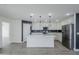 Modern kitchen with white cabinets, stainless steel appliances, and a large island at 2749 E Wier Ave, Phoenix, AZ 85040