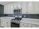 Updated kitchen featuring stainless steel appliances, quartz counters, and modern hardware at 2749 E Wier Ave, Phoenix, AZ 85040