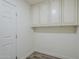 This laundry room features a row of overhead cabinets for storage at 2749 E Wier Ave, Phoenix, AZ 85040