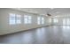 Bright living room with many windows, recessed lighting, modern ceiling fan, and light gray wood-look flooring at 2749 E Wier Ave, Phoenix, AZ 85040