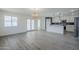 Bright open-concept space with wood floors connecting the living room and kitchen at 2749 E Wier Ave, Phoenix, AZ 85040