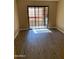 Bedroom featuring vinyl plank flooring and a sliding glass door to a private balcony at 3131 W Cochise Dr # 218, Phoenix, AZ 85051