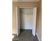 Open closet with bi-fold doors, a rod, and neutral paint and flooring at 3131 W Cochise Dr # 218, Phoenix, AZ 85051