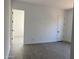 Neutral bedroom with ample space, gray wood-look tile flooring and natural light at 31512 N Hayweather Ln, San Tan Valley, AZ 85143