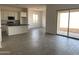 Open-concept living space featuring sliding glass doors and stylish gray wood-look tile flooring at 31512 N Hayweather Ln, San Tan Valley, AZ 85143