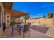 Inviting backyard featuring a covered patio, dining set, pool, and easy-care landscaping at 3408 W Taro Ln, Phoenix, AZ 85027