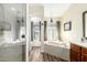 Bathroom features a shower, soaking tub under a window, vanity and hardwood floors at 3408 W Taro Ln, Phoenix, AZ 85027