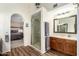 Bathroom with glass shower, single vanity, with an arched doorway to main bedroom at 3408 W Taro Ln, Phoenix, AZ 85027