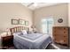 Comfortable bedroom with a ceiling fan, window, and dresser with decorative wall hangings at 3408 W Taro Ln, Phoenix, AZ 85027