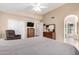 Spacious bedroom featuring a ceiling fan, closet, dresser, chair, and decorative mirror at 3408 W Taro Ln, Phoenix, AZ 85027