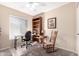 Bedroom with window, desk, rocking chair, bookshelf and neutral color scheme at 3408 W Taro Ln, Phoenix, AZ 85027