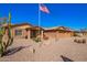 A well-maintained home with a three-car garage, an American flag, and xeriscaping in the front yard at 3408 W Taro Ln, Phoenix, AZ 85027