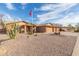 Single-story brick home featuring desert landscaping, a three-car garage, and an American flag at 3408 W Taro Ln, Phoenix, AZ 85027