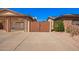 Three-car garage with direct access, concrete driveway and gated access to backyard at 3408 W Taro Ln, Phoenix, AZ 85027