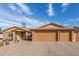 Single-story home featuring a spacious three-car garage, desert landscaping, and a paved driveway at 3408 W Taro Ln, Phoenix, AZ 85027