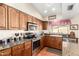 Granite countertops accent this well-lit kitchen with stainless steel appliances and wood cabinets at 3408 W Taro Ln, Phoenix, AZ 85027