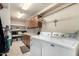 Functional laundry room with white washer, dryer, and ample storage cabinets at 3408 W Taro Ln, Phoenix, AZ 85027