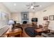 Spacious living room features a stone fireplace, ceiling fan, and wood-look flooring at 3408 W Taro Ln, Phoenix, AZ 85027