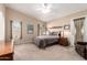 Comfortable bedroom featuring neutral tones, ceiling fan, and a private exterior access door at 3408 W Taro Ln, Phoenix, AZ 85027