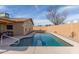 A beautiful swimming pool with a light-colored concrete deck and a beige wall in the background at 3408 W Taro Ln, Phoenix, AZ 85027