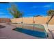 A serene backyard pool is surrounded by a beige stucco wall and light-colored concrete at 3408 W Taro Ln, Phoenix, AZ 85027