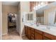 Bathroom with double sink vanity, walk-in closet, and a separate door to toilet and shower area at 3896 E Aragonite Ln, San Tan Valley, AZ 85143