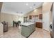 Bright kitchen with a large island, tile flooring, and views into the backyard at 3896 E Aragonite Ln, San Tan Valley, AZ 85143