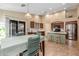 Bright kitchen with stainless steel appliances, center island, breakfast nook, and sliding glass door at 3896 E Aragonite Ln, San Tan Valley, AZ 85143