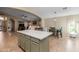 Spacious kitchen island featuring stone countertops and views to the living room at 3896 E Aragonite Ln, San Tan Valley, AZ 85143