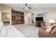 Spacious living room with custom built-ins and wood look tile flooring at 3896 E Aragonite Ln, San Tan Valley, AZ 85143