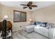 Cozy living room with wood look flooring, couch and window at 3896 E Aragonite Ln, San Tan Valley, AZ 85143