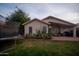 Spacious backyard featuring a covered patio with outdoor seating, a grill, and well-maintained landscaping at 4032 E Jojoba Rd, Phoenix, AZ 85044