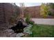 Tranquil backyard pond with a small waterfall, rock features, and lush greenery, creating a peaceful oasis at 4032 E Jojoba Rd, Phoenix, AZ 85044