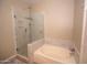 Modern bathroom with a glass shower, separate soaking tub, and neutral tile at 4032 E Jojoba Rd, Phoenix, AZ 85044