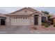 Inviting single-level home with a two-car garage, xeriscaping, and a covered entryway at 4032 E Jojoba Rd, Phoenix, AZ 85044