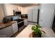 Well-lit kitchen with modern white cabinets, stainless steel appliances, and stylish countertops at 4032 E Jojoba Rd, Phoenix, AZ 85044