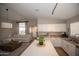 Open kitchen overlooking the living area, featuring white cabinets and a spacious island at 4032 E Jojoba Rd, Phoenix, AZ 85044